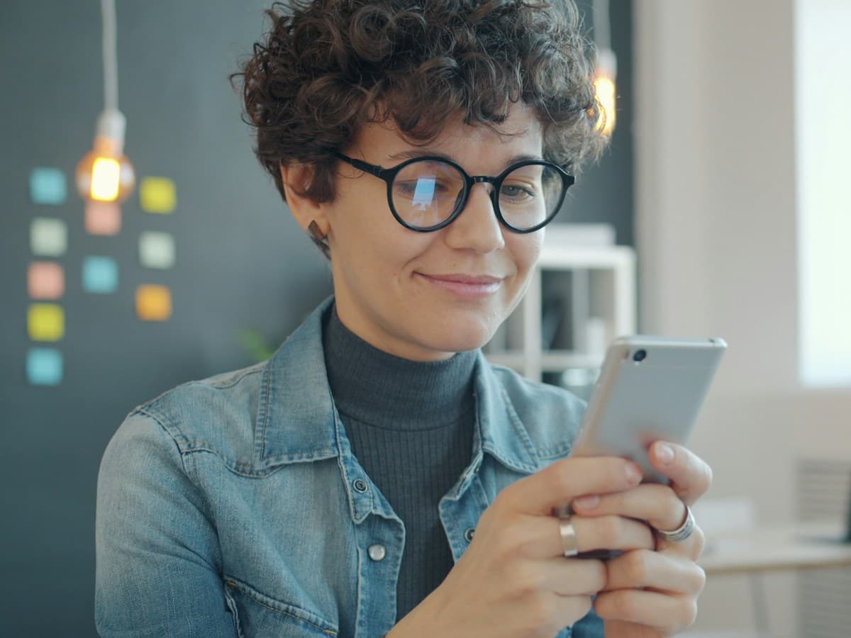A happy customer smiling at a booking confirmation on their phone